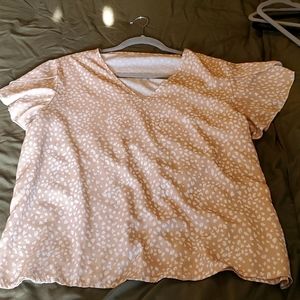 Leopard print, cream colored blouse with flutter sleeve detail.